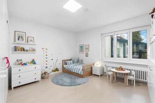 room with radiator heating unit and light wood-style flooring