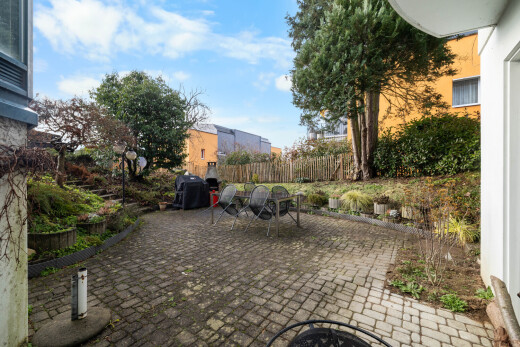 garden with a patio area, a fenced backyard, an outdoor fire pit, and grilling area
