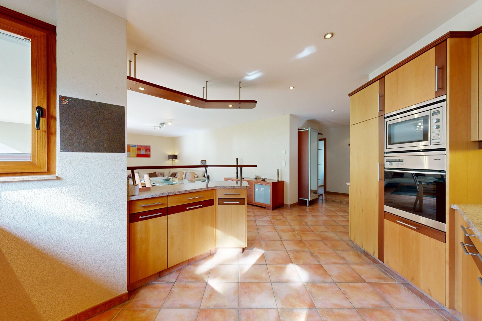 kitchen featuring stainless steel appliances, a peninsula, light tile patterned floors, and recessed lighting