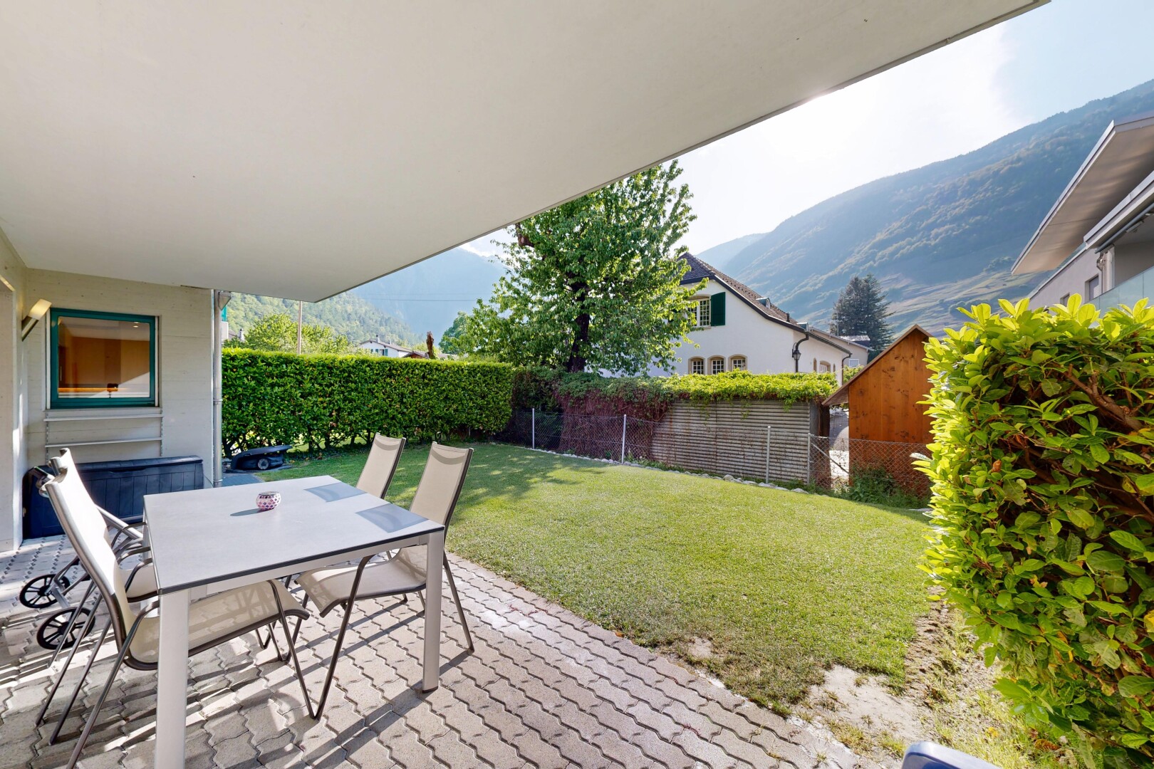 terrace featuring outdoor dining area, a fenced backyard, a patio area, and a mountain view