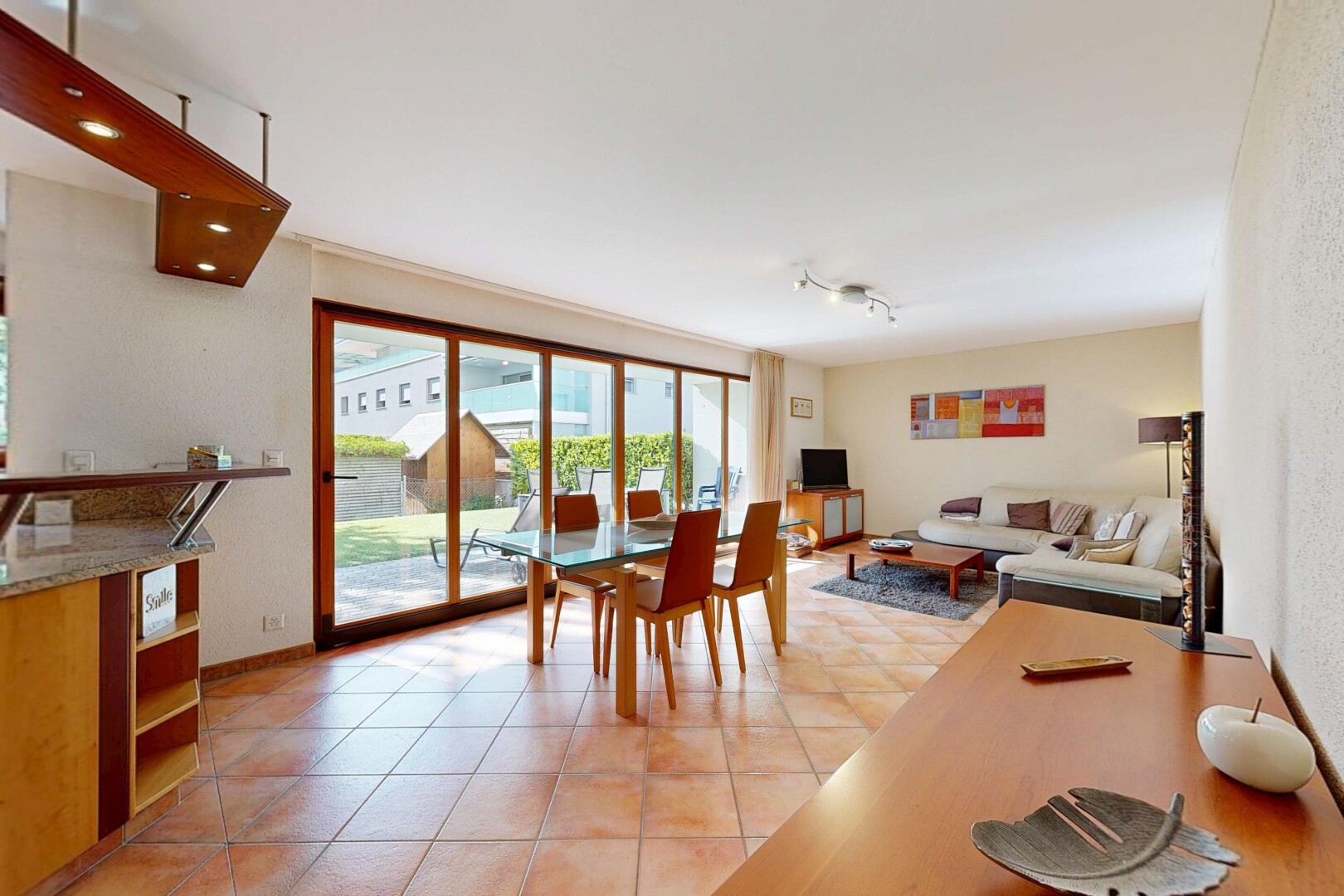 living area featuring light tile patterned floors and baseboards