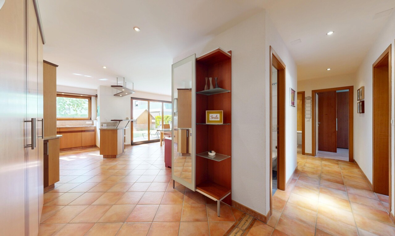 hallway with light tile patterned floors, recessed lighting, and healthy amount of natural light