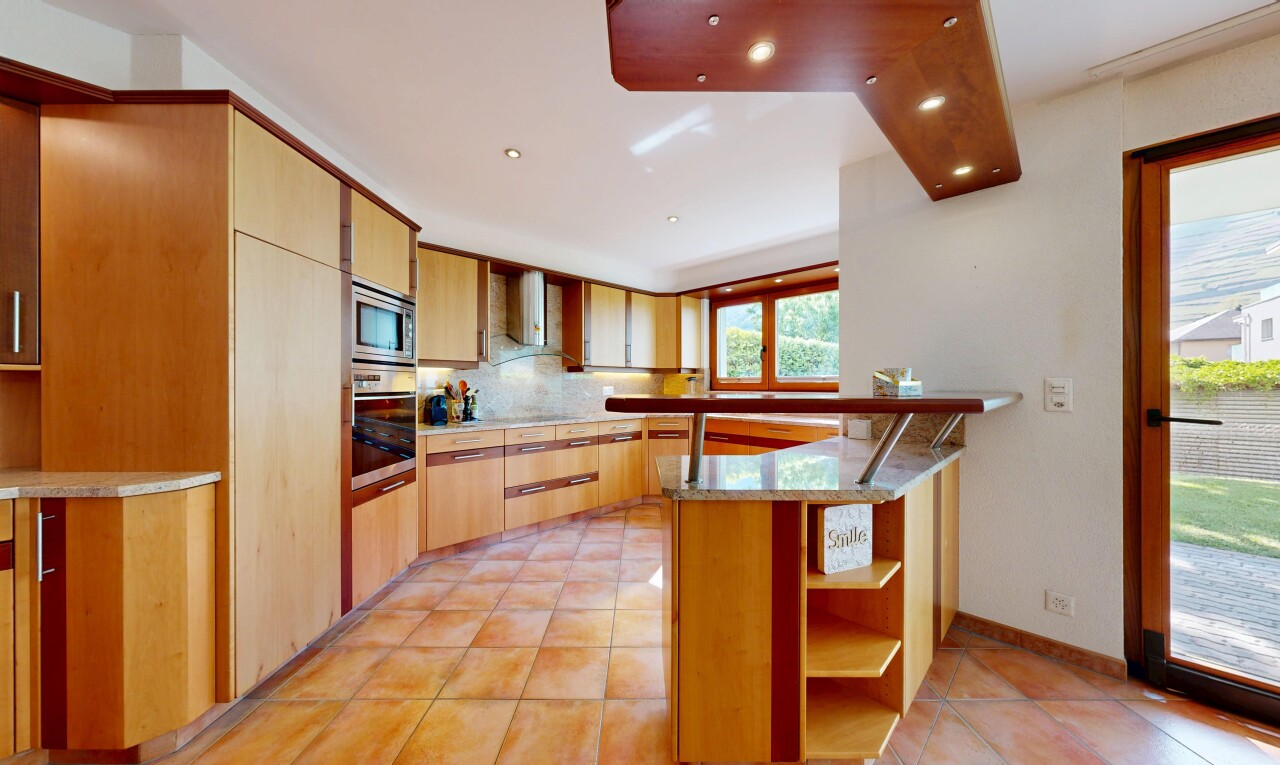 kitchen with backsplash, light tile patterned floors, stainless steel appliances, light stone counters, and exhaust hood