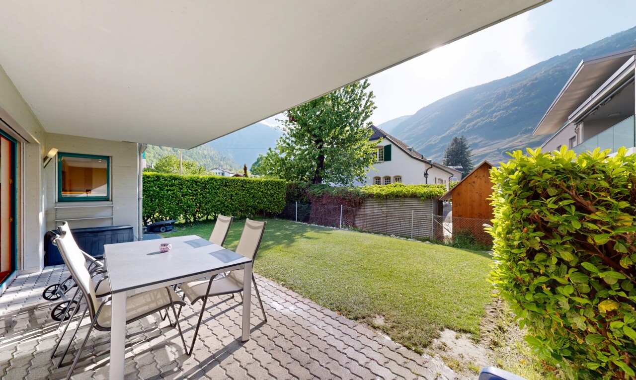 terrace featuring outdoor dining area, a fenced backyard, a patio area, and a mountain view