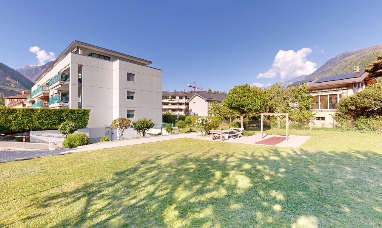 view of home featuring a lawn, a mountain view, and stucco siding