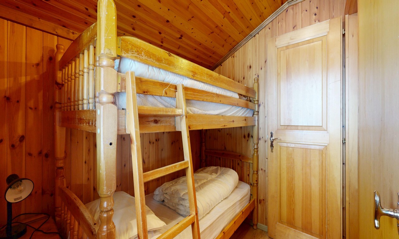 chambre avec mur en bois, wood wall, inside property, plafond voûté, et vaulted ceiling