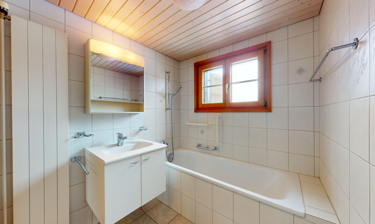 bad mit kombiniertes bad / dusche, spiegel, natürliches licht, fliesenwand, und waschbecken