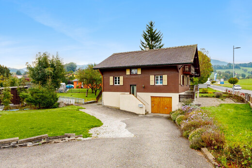 view of property with a yard and driveway