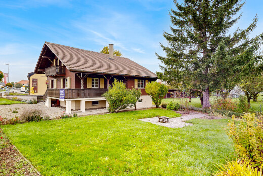view of home featuring a yard, a chimney, a fire pit, and a patio area