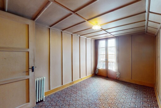 unfurnished room featuring lofted ceiling and radiator