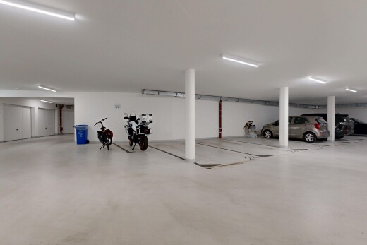 view of parking with a parking garage