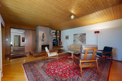 living area with light wood-type flooring, a fireplace, and wooden ceiling