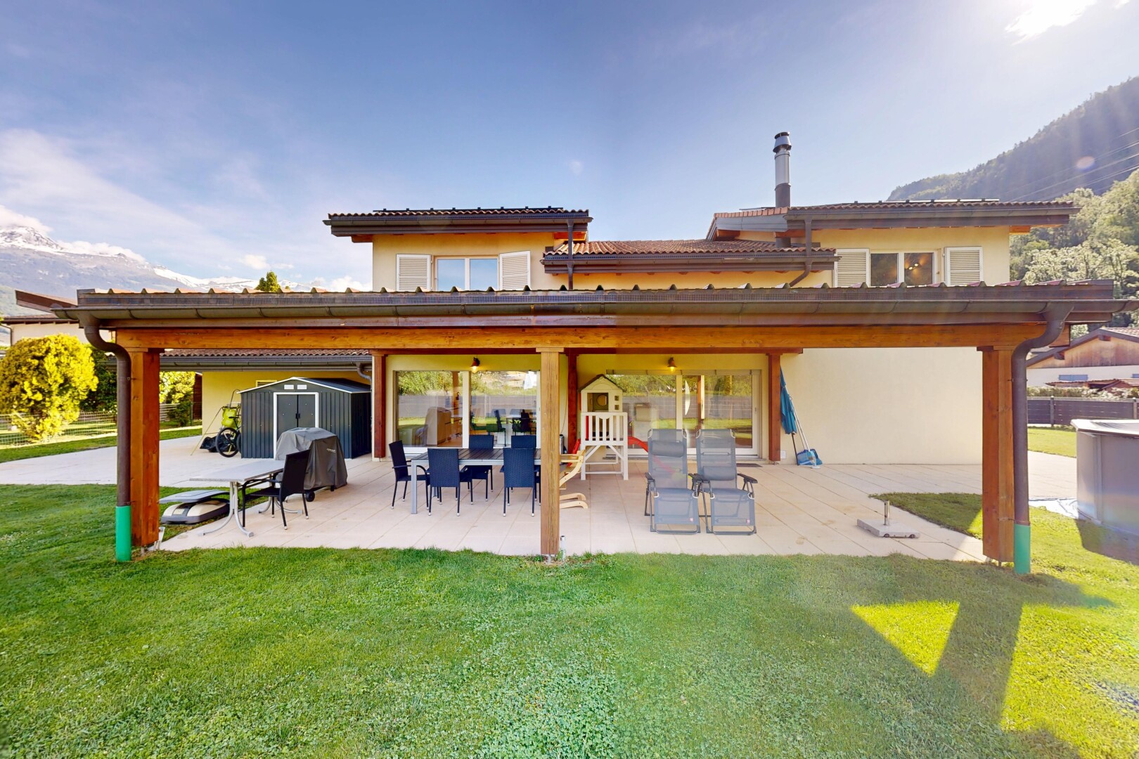 outdoor house with a patio, a shed, and a lawn