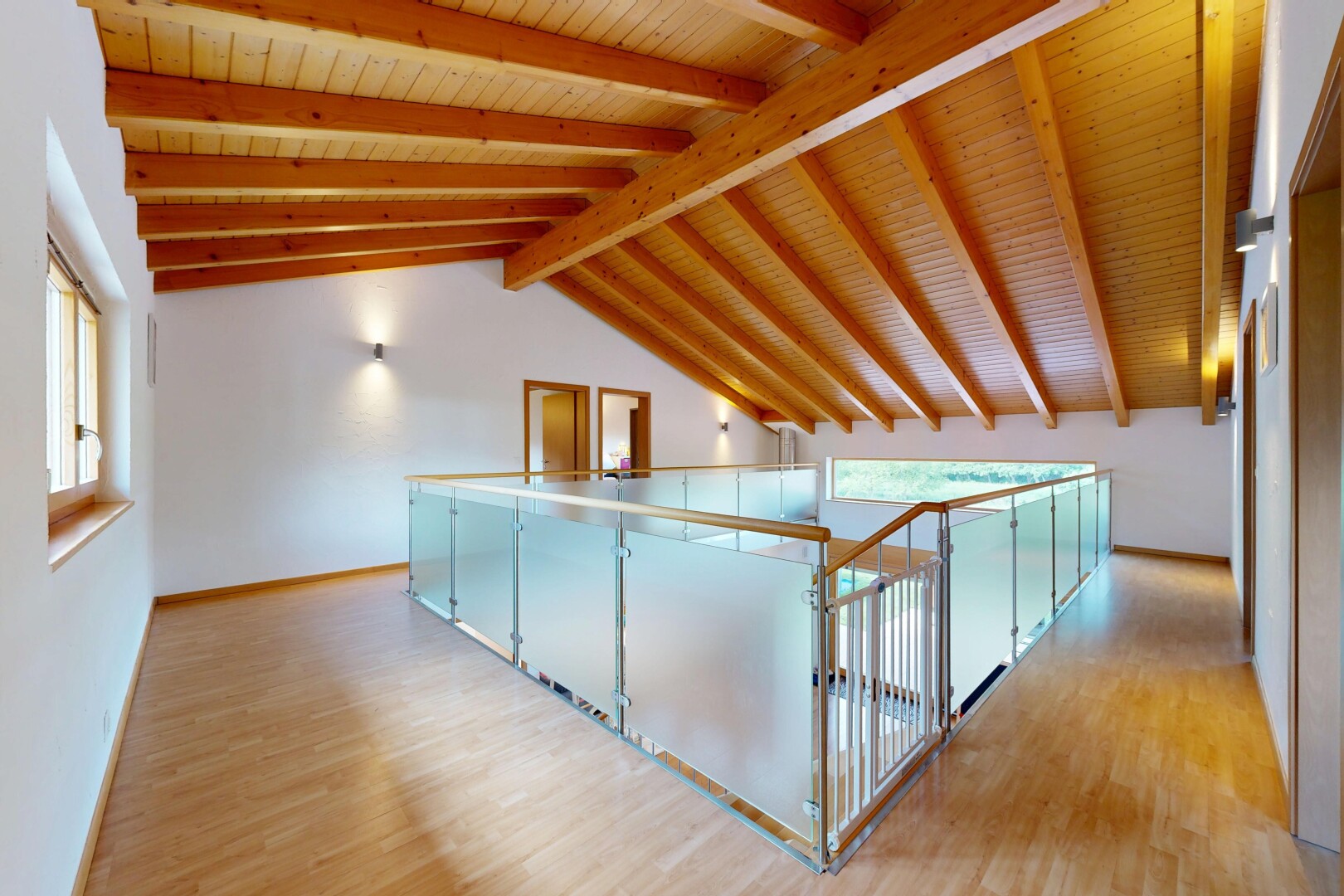 hallway with light wood-style floors and a wood ceiling with exposed beams