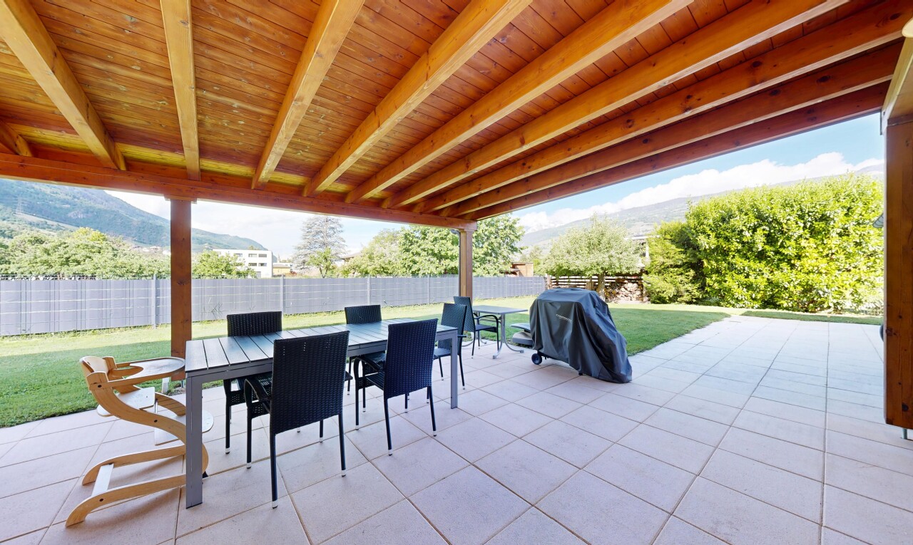 terrace featuring a patio, outdoor dining space, a fenced backyard, a grill, and a mountain view