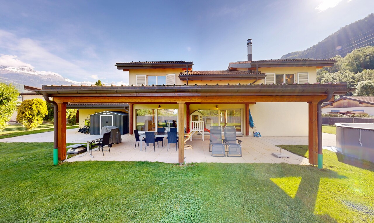 outdoor house with a patio, a shed, and a lawn