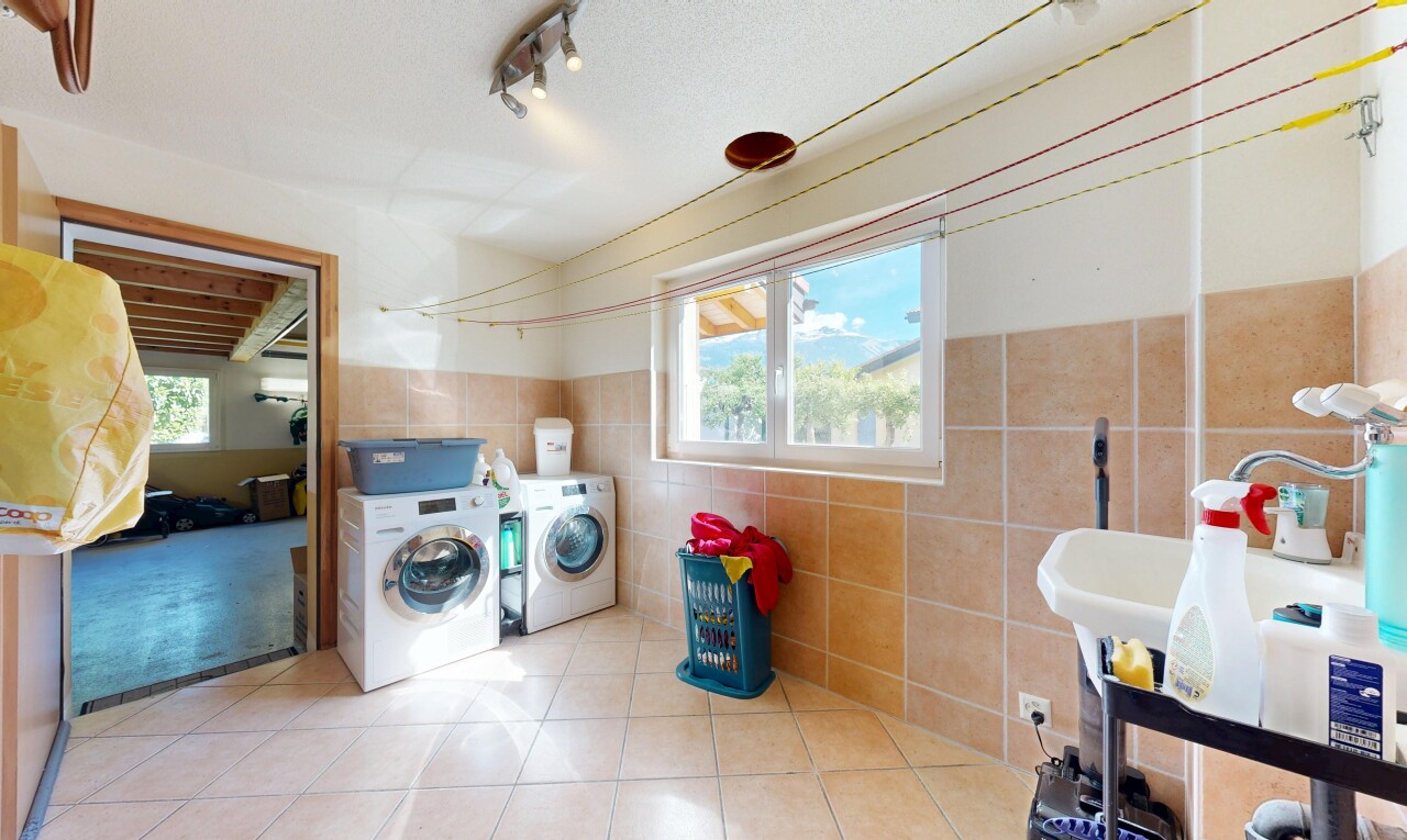 laundry room with separate washer and dryer, light tile patterned floors, wainscoting, and track lighting