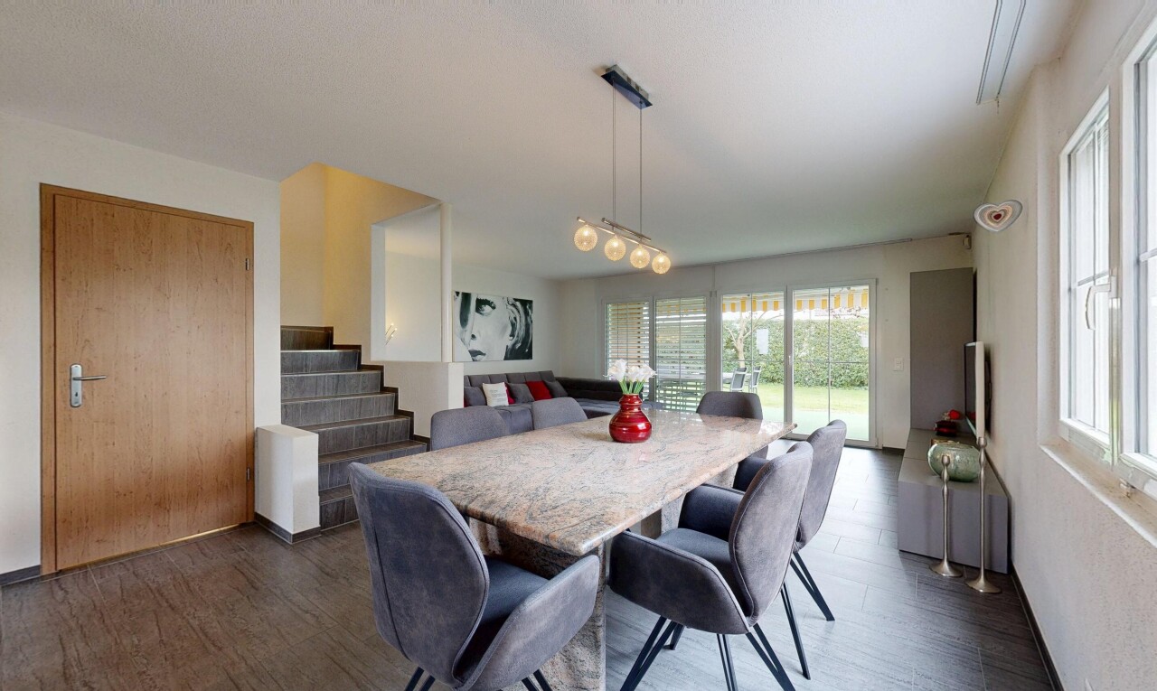 living / dining room featuring dark wood finished floors and stairway