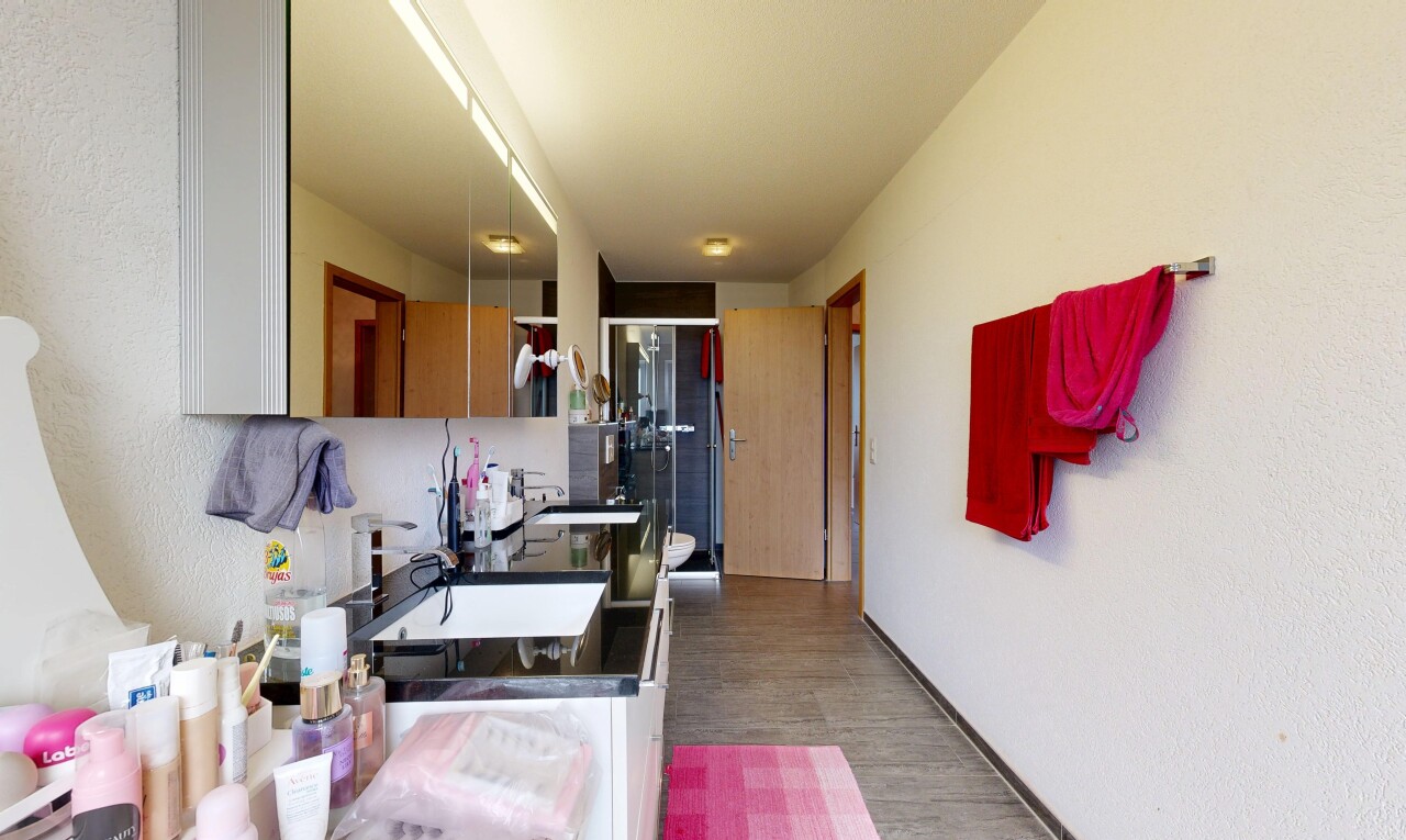 bathroom featuring a sink and dark wood finished floors
