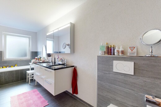 bathroom with a textured wall and vanity