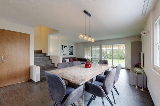 living / dining room featuring dark wood finished floors and stairway