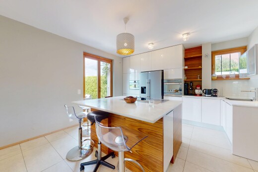 cuisine avec armoires à panneau plat, inside property, natural light, lumière naturelle, et éclairage suspendu