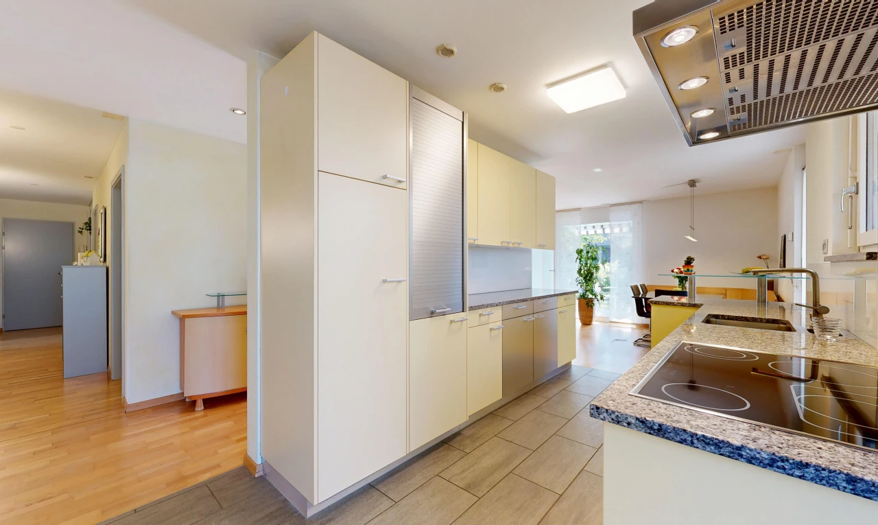 cuisine avec hotte, light floor, évier, drywall, et cloison sèche