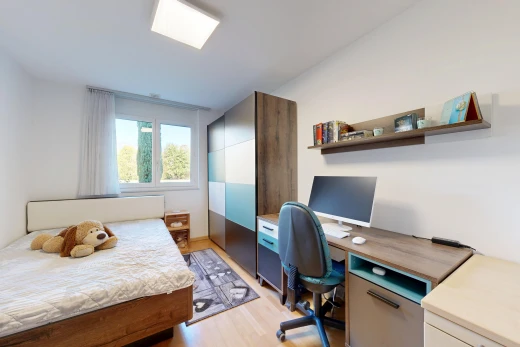 chambre avec télévision, light floor, cloison sèche, drywall, et sol en finition bois