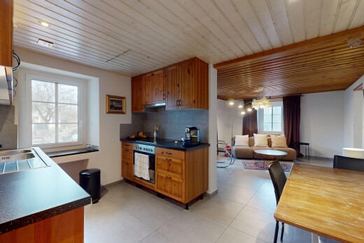 küche mit arbeitsplatten, natürliches licht, dunstabzugshaube, ofen, und mittelbraune schränke